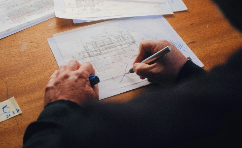 Due mani tracciano delle connessioni su un progetto di leadership.